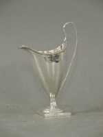 Lot 303 - A George III helmet shaped cream jug