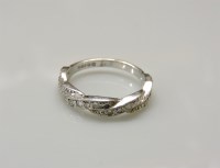 Lot 16 - An 18ct white gold diamond set twisted ribbon half eternity ring