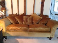 Lot 656 - A large gold velvet upholstered sofa