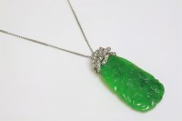 Lot 458 - A carved jade and diamond pendant