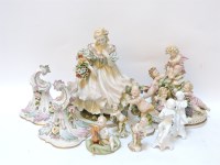 Lot 199 - A Capodimonte porcelain figurine of a girl holding a basket of flowers
