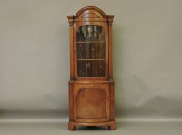 Lot 428 - A reproduction walnut floor standing corner cabinet