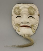 Lot 568 - A Japanese carved soft wood Noh mask