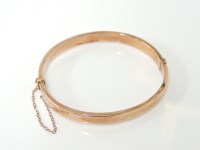 Lot 1060 - A 9ct rose gold bangle