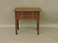 Lot 1563 - A George III oak lowboy