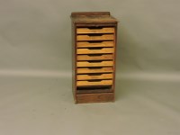 Lot 1522 - An oak and tambour fronted filing cabinet