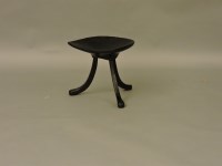 Lot 1611 - A Thebes ebonised three legged stool