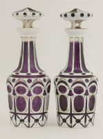 Lot 52 - A pair of Bohemian overlaid purple glass decanters and stoppers