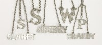 Lot 230 - Three William IV/Victorian silver cut out letter wine labels
