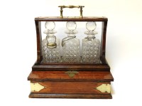 Lot 382 - An oak and silver plate mounted three bottle Tantalus