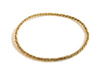 Lot 58 - A gold twisted rope slave bangle