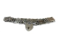 Lot 17 - A gold four bar gate link bracelet with padlock