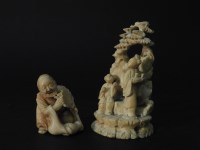 Lot 184 - An ivory netsuke of a crouching woman holding a fan