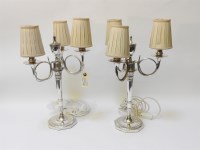 Lot 370 - A pair of silver plated three branch candelabra table lamps