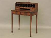 Lot 682 - A Georgian style mahogany Bonheur du Jour with pigeon holes and drawers
