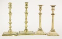 Lot 127 - Two pairs of brass candlesticks