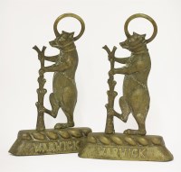Lot 84 - Two brass door stops