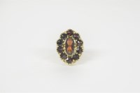 Lot 21 - A Portuguese gold garnet cluster ring stamped 800