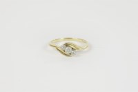 Lot 34 - A gold three stone diamond cross over ring