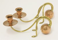 Lot 50 - A pair of Arts and Crafts brass and copper cantilever candlesticks