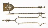 Lot 32 - An Arts & Crafts steel three-piece fireside set