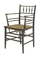 Lot 60 - A 'Sussex' ebonised armchair