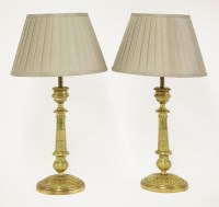 Lot 152 - A pair of gilt metal candlesticks