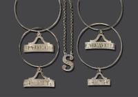 Lot 232 - A pair of George III silver neck ring wine labels