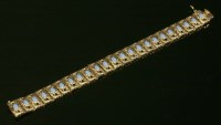 Lot 231 - An Italian gold and blue paste cabochon bracelet