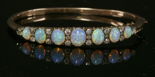 Lot 67 - A late Victorian opal and diamond hinged bangle