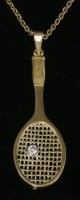 Lot 282 - A single stone diamond tennis racket pendant and chain