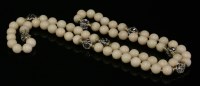 Lot 243 - A single row angel skin coral and rock crystal necklace