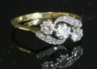 Lot 288 - A three stone diamond crossover ring