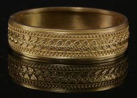 Lot 34 - A Victorian gold flat section hinged Etruscan-style bangle
