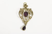 Lot 13 - An Edwardian gold amethyst and split pearl drop pendant