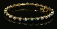 Lot 97 - A late Victorian turquoise and split pearl hinged bangle