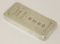 Lot 557 - A paperweight in the form of a silver ingot
