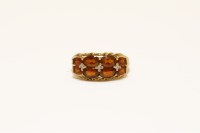 Lot 31 - A 9ct gold two row Madeira citrine and diamond points ring