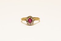 Lot 28 - An 18ct gold ruby and diamond illusion set cluster ring