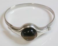 Lot 54 - A Norwegian modernist silver tiger's eye bangle