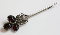 Lot 19 - A silver Arts and Crafts garnet bar brooch