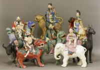 Lot 451 - A set of eight enamelled and gilt biscuit porcelain Daoist immortals