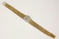 Lot 439 - A ladies' 18ct gold Bucherer mechanical bracelet watch with a diamond set bezel