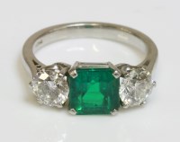 Lot 561 - A three stone emerald and diamond ring
