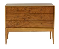 Lot 658 - A teak and walnut chest of four drawers