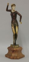 Lot 521 - A patinated and spelter figure of a dancer