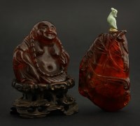 Lot 147 - An amber Budai