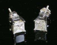 Lot 325 - A pair of white gold single stone diamond stud earrings