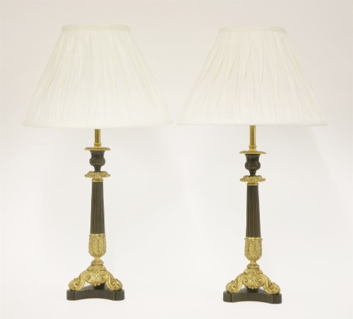 Lot 85 - A pair of parcel-gilt candlesticks