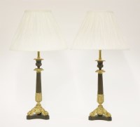 Lot 85 - A pair of parcel-gilt candlesticks